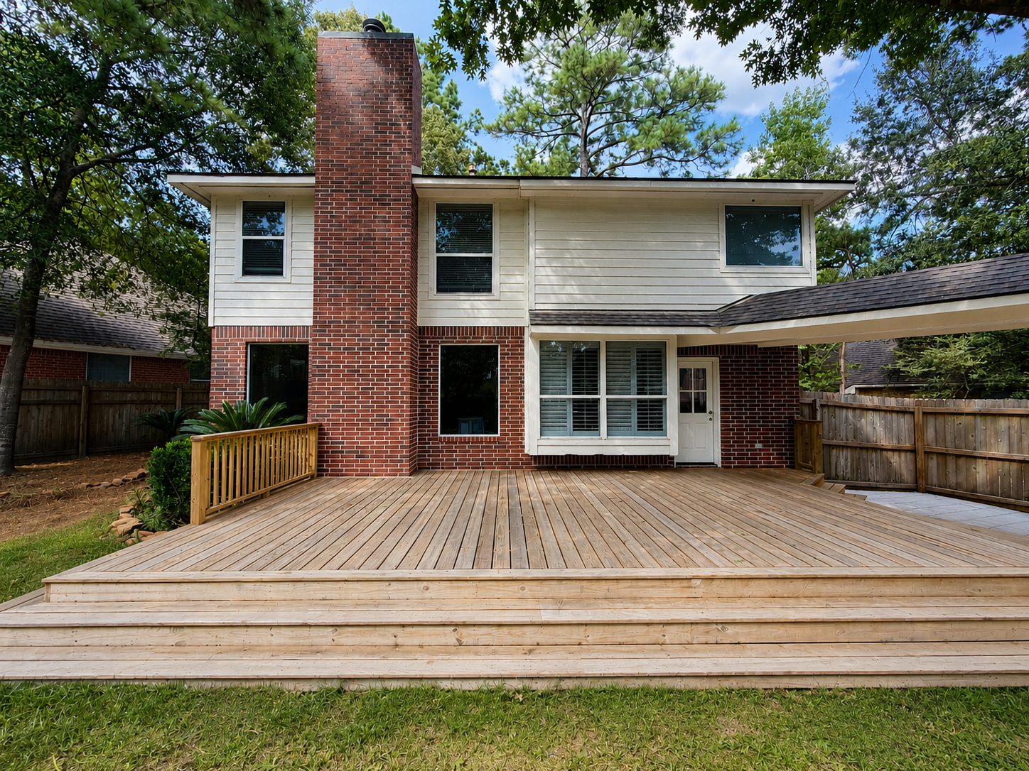 The backdoor entry and brick facade are beautifully framed by established landscaping and a canopy of mature trees. The backdoor entry and brick facade are beautifully framed by established landscaping and a canopy of mature trees.